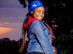 girl outside during sunset turned sideways and looking at camera smiling